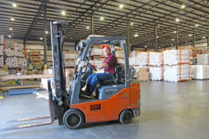 A man driving a lift representing services of third party logistics provider Days Distribution & Logistics in Elkhart, IN